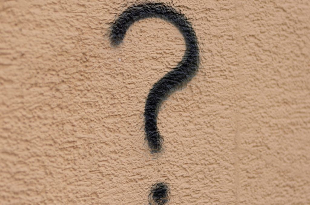 Black question mark on a brown background